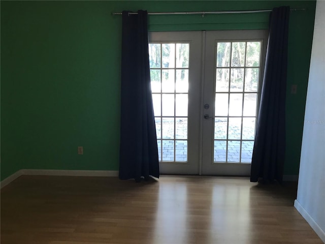 entryway with hardwood / wood-style floors and french doors