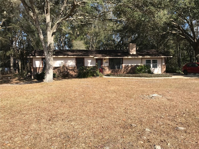 ranch-style house featuring a front lawn