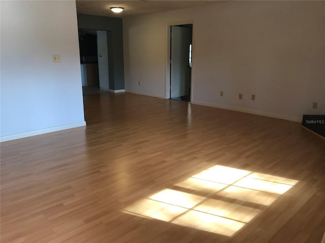 empty room with light hardwood / wood-style flooring