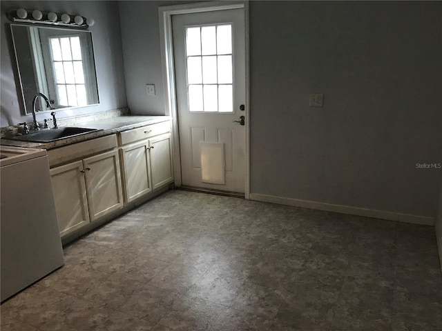 kitchen with stove, sink, and plenty of natural light