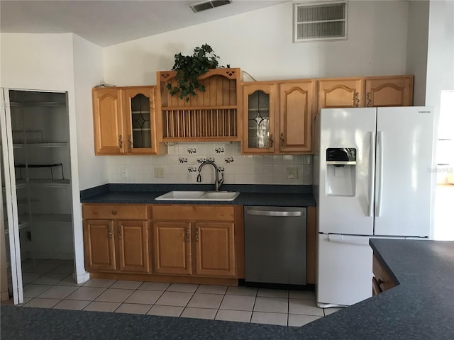 kitchen with sink, decorative backsplash, white refrigerator with ice dispenser, and dishwasher