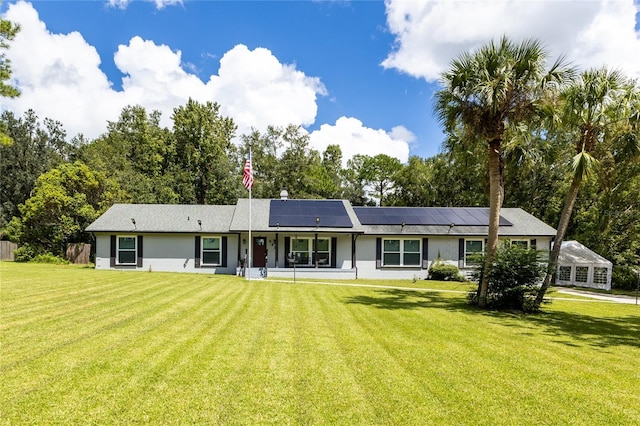 ranch-style house with a front lawn and solar panels