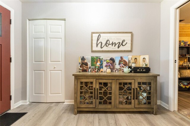 bar featuring baseboards and wood finished floors