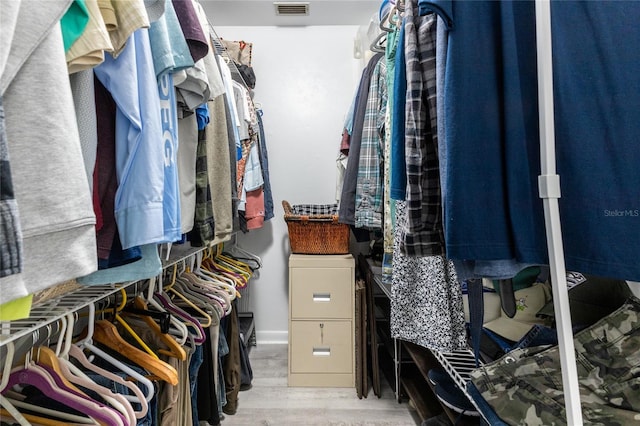 walk in closet featuring visible vents and wood finished floors