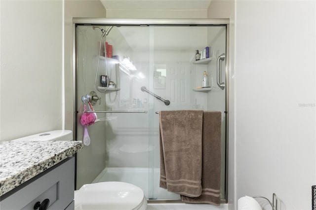 full bathroom with toilet, a shower stall, and vanity