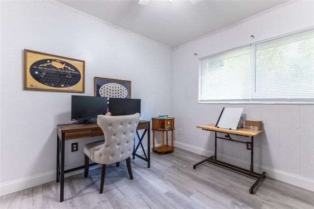 office featuring crown molding, light wood-style flooring, and baseboards