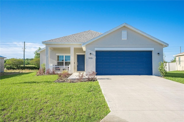 view of front of home featuring a garage and a front yard