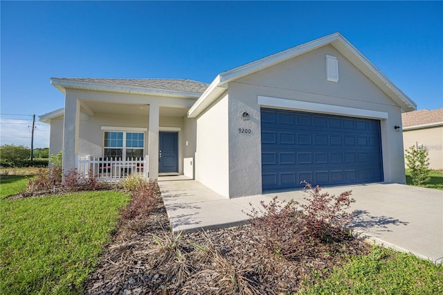 ranch-style home featuring a garage and a front lawn