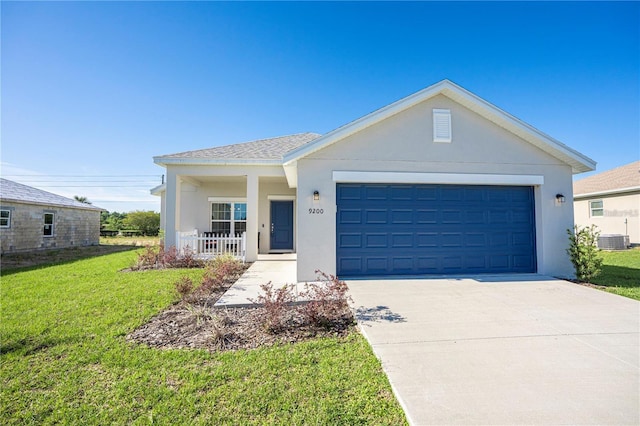 single story home with a garage, concrete driveway, a front lawn, and stucco siding