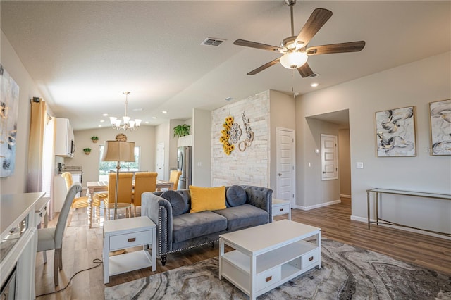 living area with recessed lighting, ceiling fan with notable chandelier, dark wood-style flooring, visible vents, and baseboards