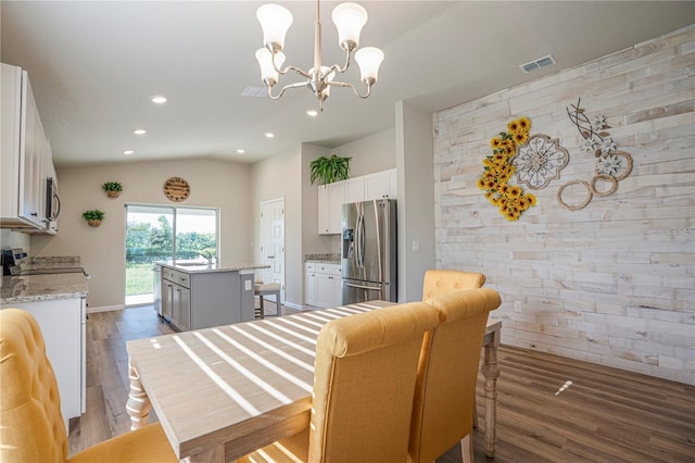 dining area featuring dark wood-type flooring, recessed lighting, visible vents, and vaulted ceiling