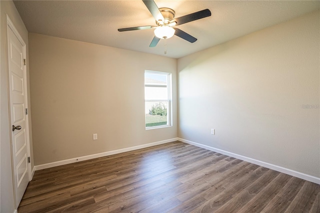 unfurnished bedroom featuring a ceiling fan, dark wood-style flooring, and baseboards