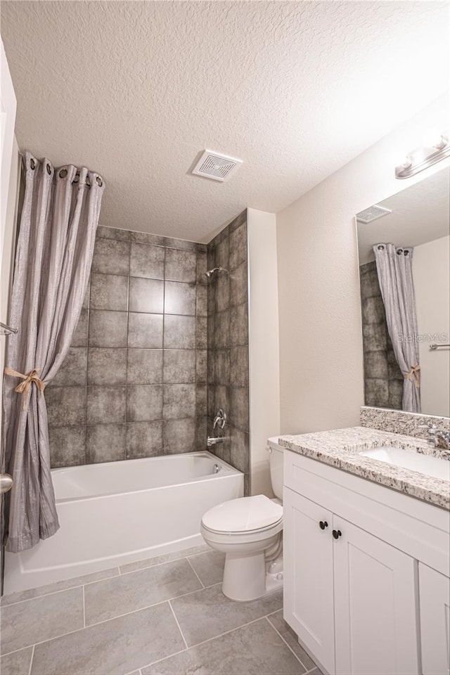 bathroom featuring visible vents, toilet, vanity, a textured ceiling, and shower / bath combination with curtain