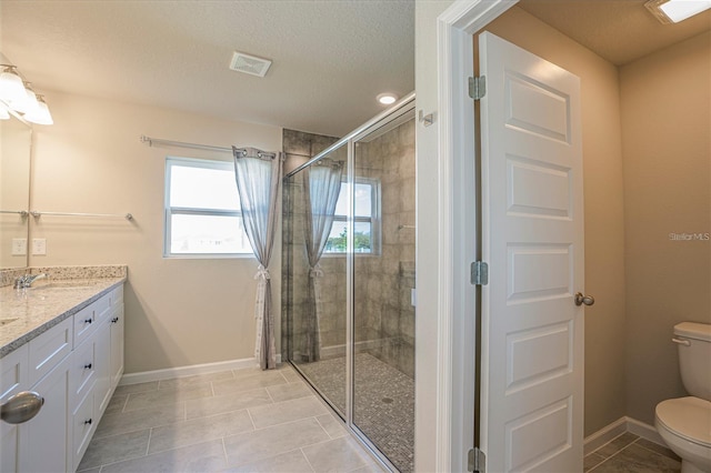 bathroom with double vanity, visible vents, baseboards, toilet, and a shower stall