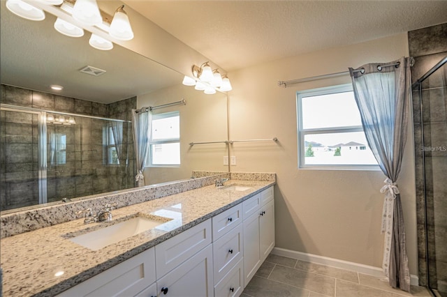 full bath with a shower stall, a sink, and a healthy amount of sunlight