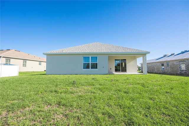 back of house with a yard, a patio, and stucco siding