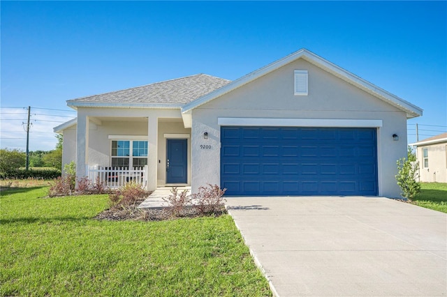 single story home featuring a front yard, a porch, concrete driveway, and stucco siding