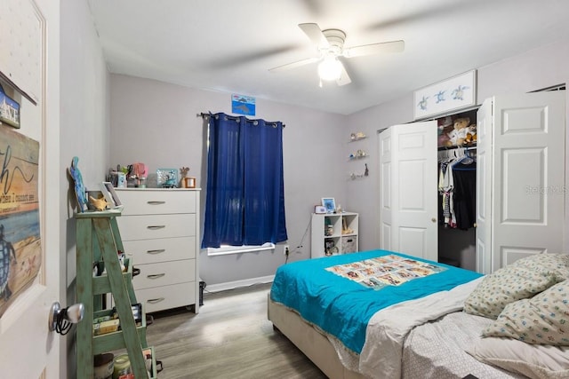 bedroom with a closet, ceiling fan, and light hardwood / wood-style floors