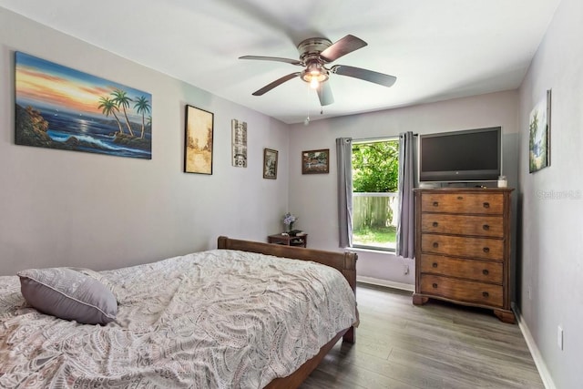 bedroom with hardwood / wood-style floors and ceiling fan