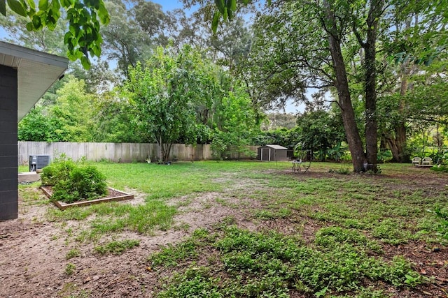 view of yard featuring a storage unit and central AC