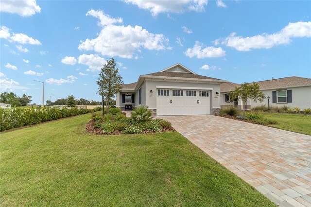 view of front of house with a garage and a front lawn