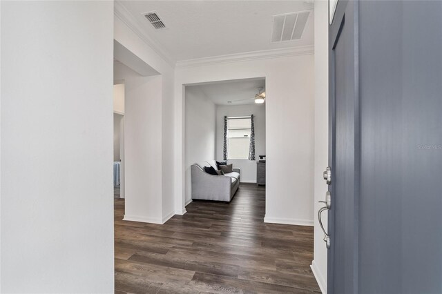 hall with ornamental molding and dark hardwood / wood-style floors