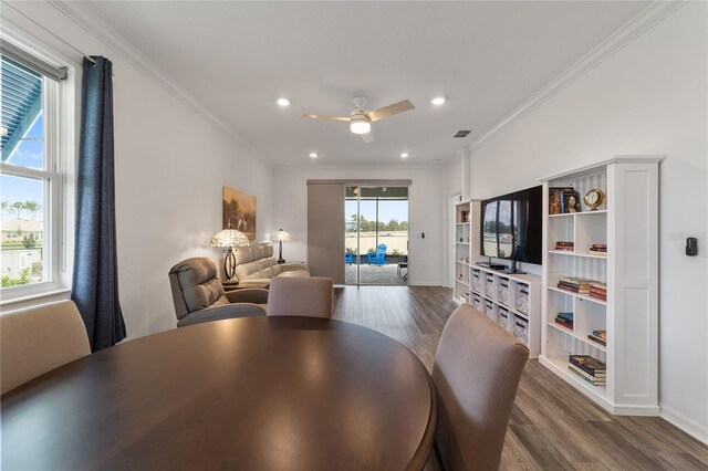 dining space featuring crown molding, dark hardwood / wood-style floors, ceiling fan, and plenty of natural light