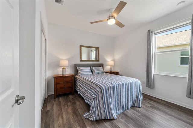 bedroom with ceiling fan and dark hardwood / wood-style floors