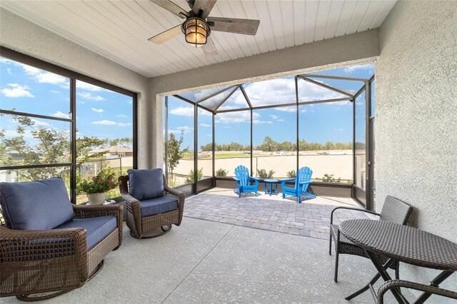 sunroom / solarium with ceiling fan and wood ceiling