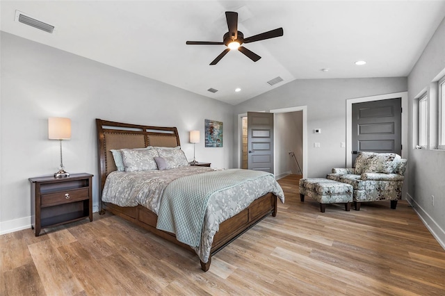 bedroom with hardwood / wood-style flooring, ceiling fan, and vaulted ceiling