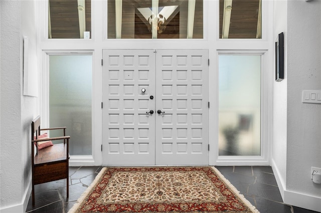 entryway featuring dark tile patterned floors