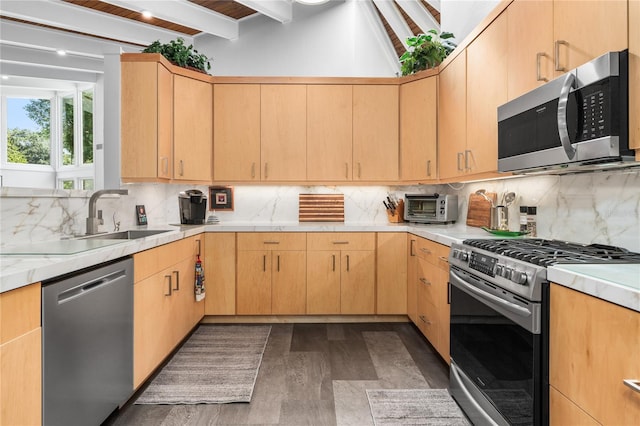 kitchen with dark wood-type flooring, tasteful backsplash, stainless steel appliances, and beam ceiling