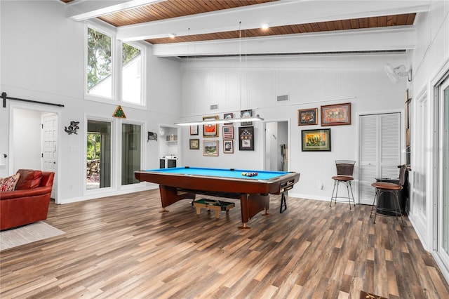 playroom featuring pool table, hardwood / wood-style flooring, a barn door, high vaulted ceiling, and beam ceiling