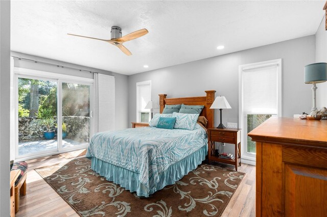 bedroom featuring access to exterior, ceiling fan, and hardwood / wood-style flooring