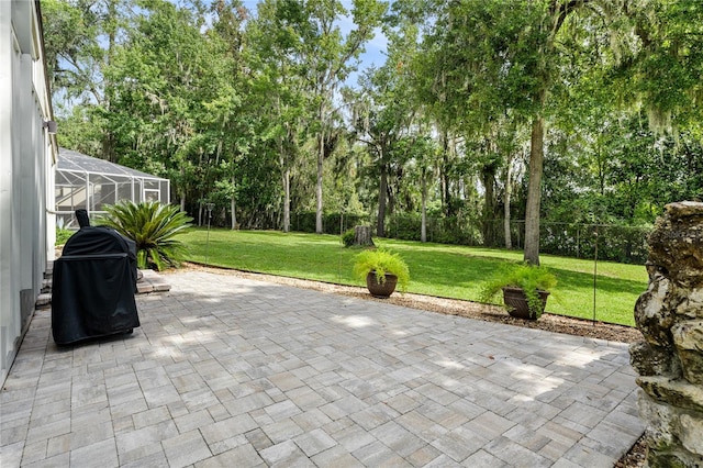 view of patio featuring grilling area and glass enclosure