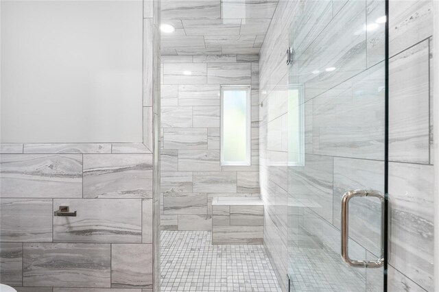 bathroom featuring a shower with shower door