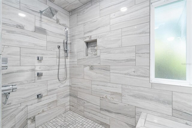 bathroom with tiled shower