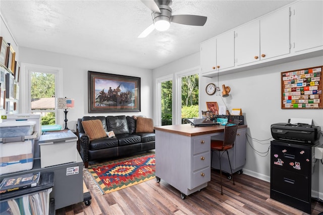 office area featuring dark wood-type flooring, a textured ceiling, and ceiling fan