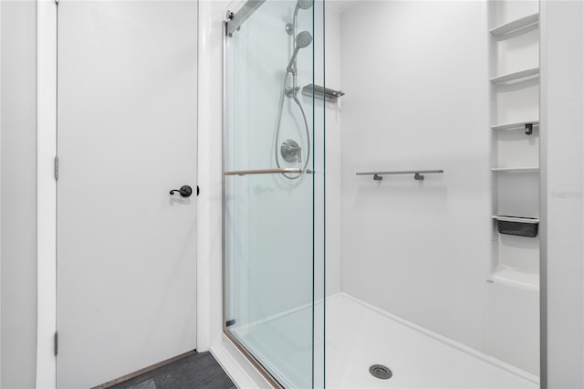 bathroom featuring a shower with shower door