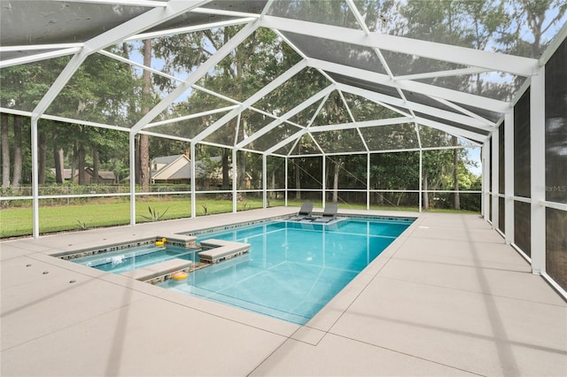 view of pool with a lanai, a patio, a lawn, and an in ground hot tub