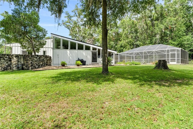 view of yard featuring glass enclosure