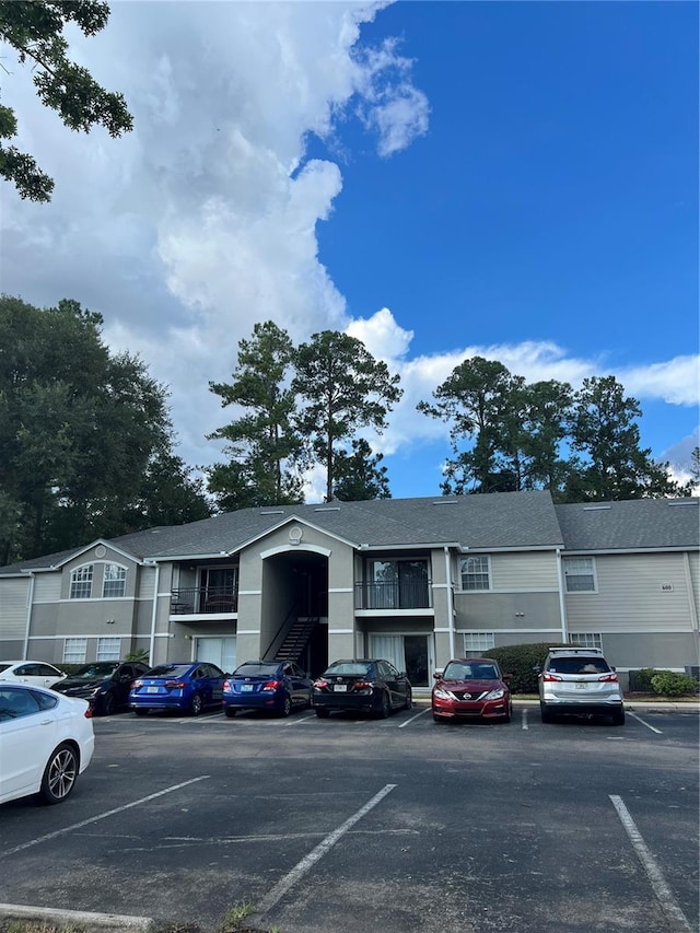 view of building exterior featuring uncovered parking