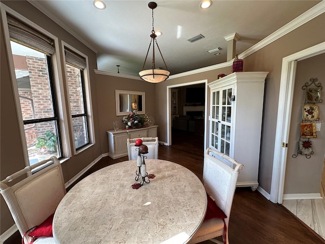 dining area featuring crown molding and dark hardwood / wood-style floors