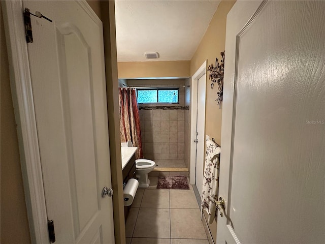 bathroom with vanity, a shower with curtain, toilet, and tile patterned flooring