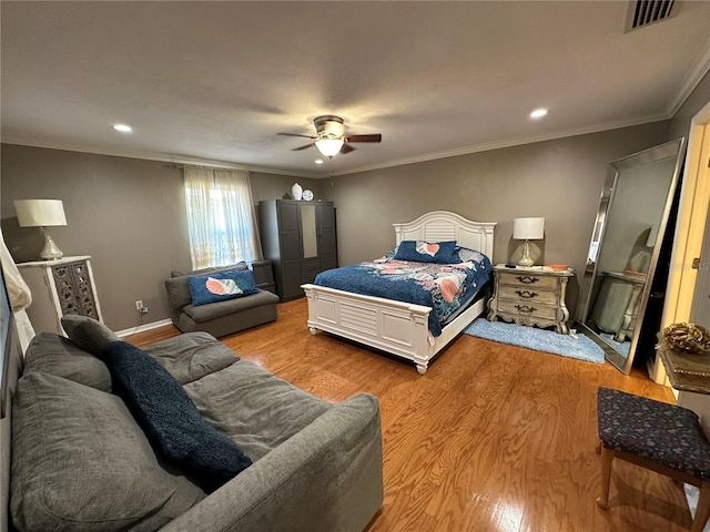 bedroom featuring ceiling fan, ornamental molding, and light hardwood / wood-style floors