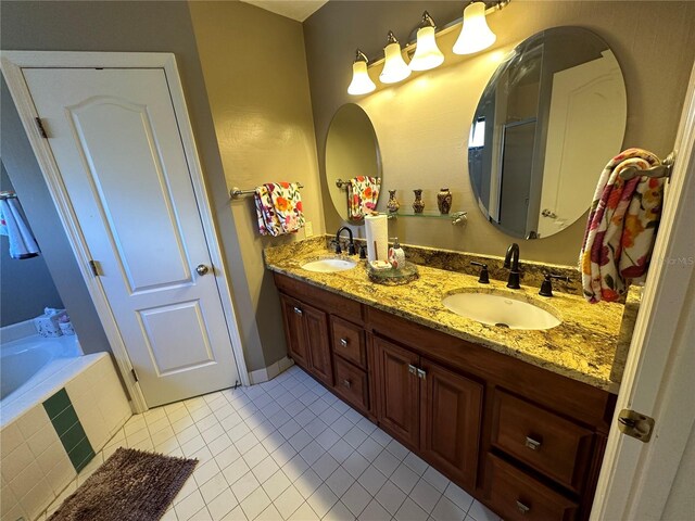 bathroom featuring vanity, a relaxing tiled tub, and tile patterned floors