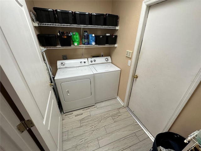 laundry room featuring light hardwood / wood-style floors and washing machine and clothes dryer