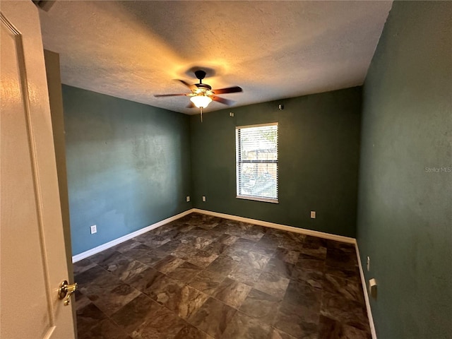 unfurnished room with a textured ceiling and ceiling fan