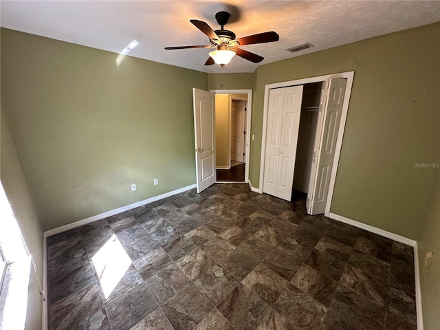 unfurnished bedroom featuring a closet and ceiling fan