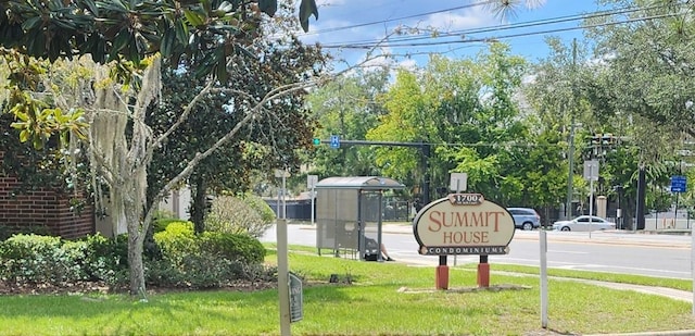 community / neighborhood sign with a yard